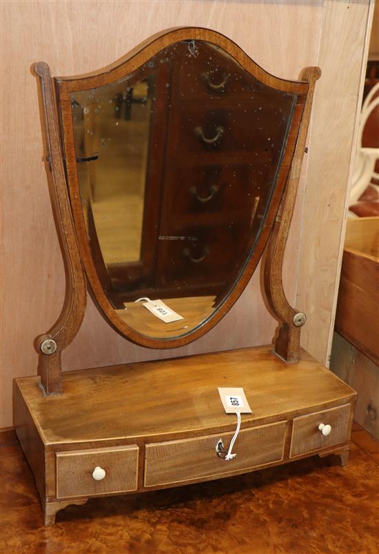 A mahogany shield shaped toilet mirror with bevelled edge